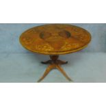 A 19th century Continental walnut and satinwood inlaid circular table raised on fluted quadruped