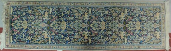 A floral runner depicting a wildlife scene on a midnight blue field within corresponding borders