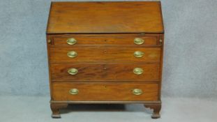 A Georgian mahogany bureau with secret compartment inside fitted interior above four long graduating