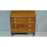 A Georgian mahogany bureau with secret compartment inside fitted interior above four long graduating