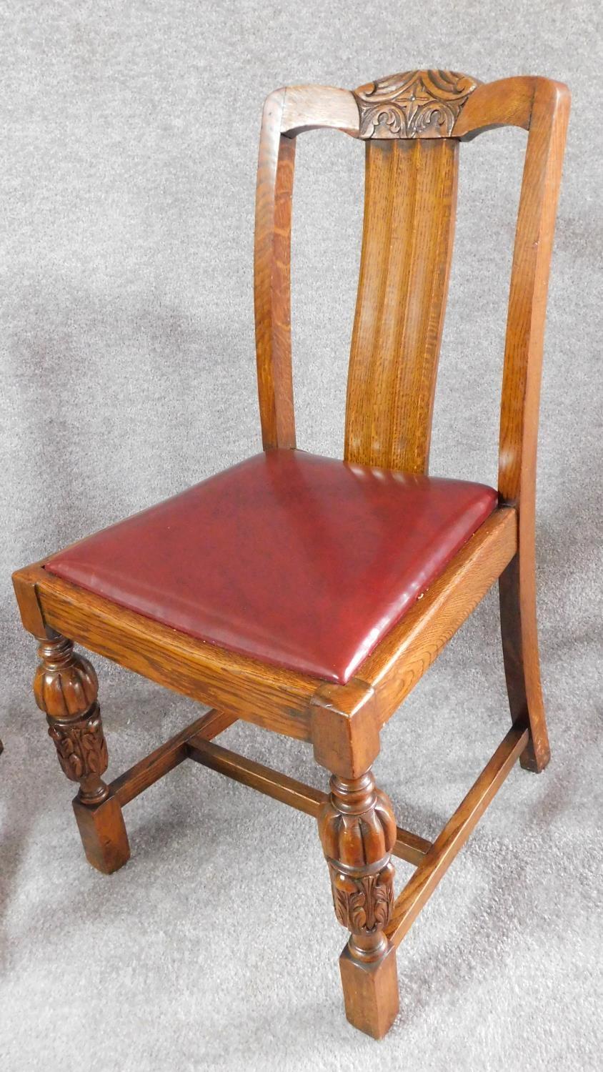 A set of four mid 20th century oak dining chairs with carved cresting in the Jacobean style. H.87cm - Image 2 of 8