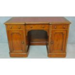 A Victorian mahogany kneehole desk with red leather top, on plinth base with casters. H.76 W.122 D.