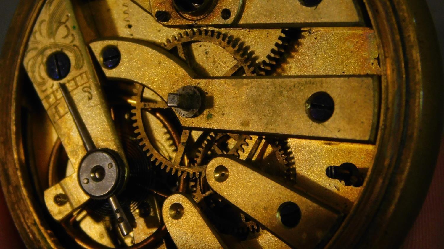 An antique brass pocket watch with bevelled glass and white enamel dial with black Roman numerals, - Image 7 of 9