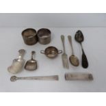 A collection of silver items, including caddy spoons, napkin ring, cutlery, salt spoon and sealing