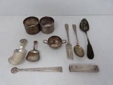 A collection of silver items, including caddy spoons, napkin ring, cutlery, salt spoon and sealing