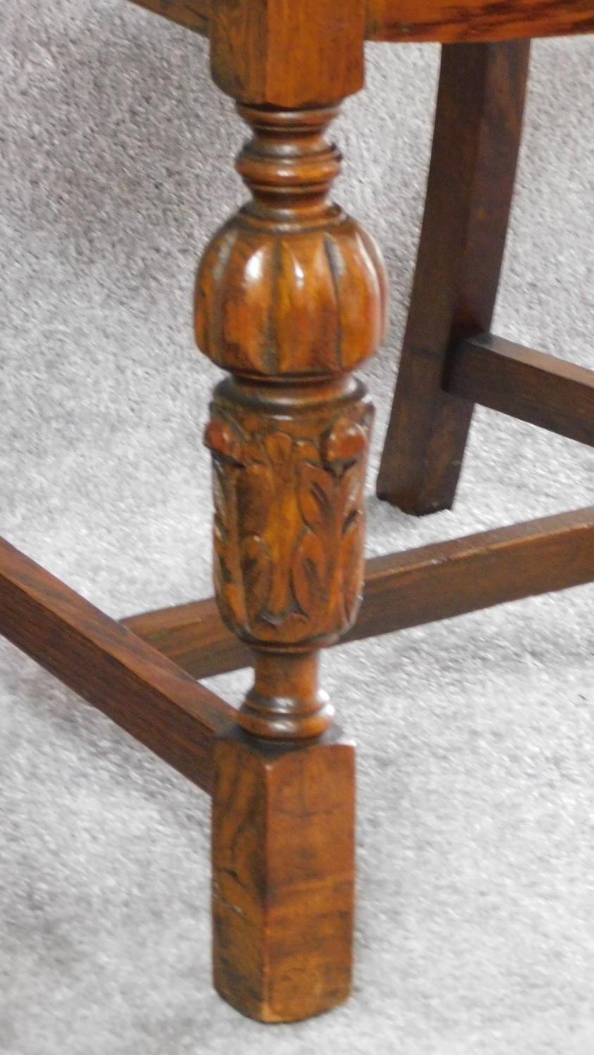 A set of four mid 20th century oak dining chairs with carved cresting in the Jacobean style. H.87cm - Image 5 of 8