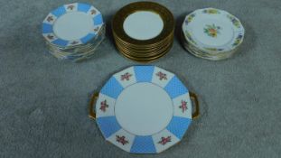 A collection of French hand painted plates with gilded detailing.