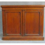 A Victorian oak two door cabinet on plinth base. H.90 W.109 D.41cm (the base to a library bookcase)