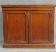 A Victorian oak two door cabinet on plinth base. H.90 W.109 D.41cm (the base to a library bookcase)