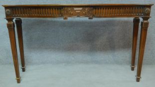 An Adam style mahogany console table on square tapering fluted supports. H.84 W.151 D.45cm