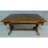 A Jacobean style oak dining table with leaves, raised on reeded stretchered turned supports. H.76