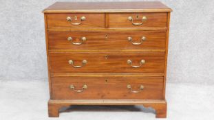 A Georgian mahogany chest of two short over three long drawers with crossbanded top on bracket feet.