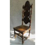 A late 19th century Carolean style oak high back hall chair with allover carving. H.131cm
