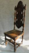 A late 19th century Carolean style oak high back hall chair with allover carving. H.131cm