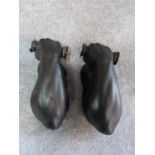 A pair of vintage black painted ceramic muscle men wall lights. The light bulbs represent the end of