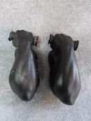 A pair of vintage black painted ceramic muscle men wall lights. The light bulbs represent the end of