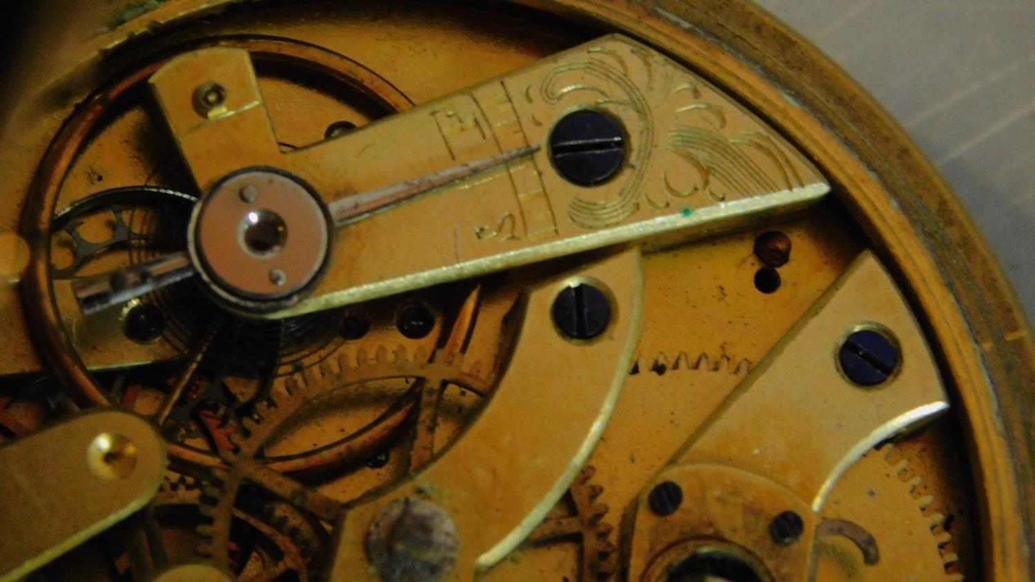 An antique brass pocket watch with bevelled glass and white enamel dial with black Roman numerals, - Image 6 of 9