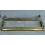 A 19th century brass fire kerb and another similar. W.132cm