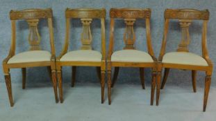 A set of four 19th century Continental walnut and satinwood inlaid chairs, lyre shaped backs on