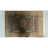 A Persian style rug with central medallion surrounded by floral motifs and a floral and geometric