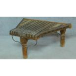 An antique Indian hardwood shaped top low table with brass studding and binding. H.38 W.87 D.64cm