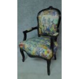 A French style ebonised armchair with comic strip upholstery. H.93cm