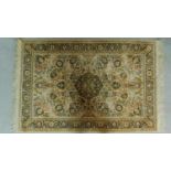 A Persian style rug with central pendant medallion on an ivory and green field with repeating floral