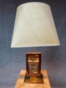 A pair of adjustable gilt metal Chinese table lamps with carved and gilded inserts signed to the