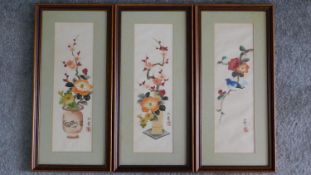 Three Chinese framed silk paintings depicting flowers and birds with artists seal. 46x22cm