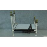 A Victorian brass and iron framed doll's bed. H.89 W.89 D.50cm