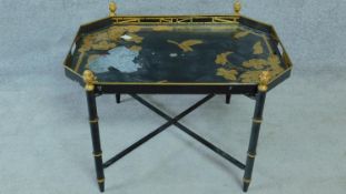 A Japanned metal butlers tray on faux bamboo base. H.48 W.71 D.51cm (some lacquer flaking)