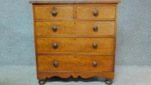 A Victorian mahogany chest of two short over three long drawers on bun feet. H.107 W.107 D.48cm