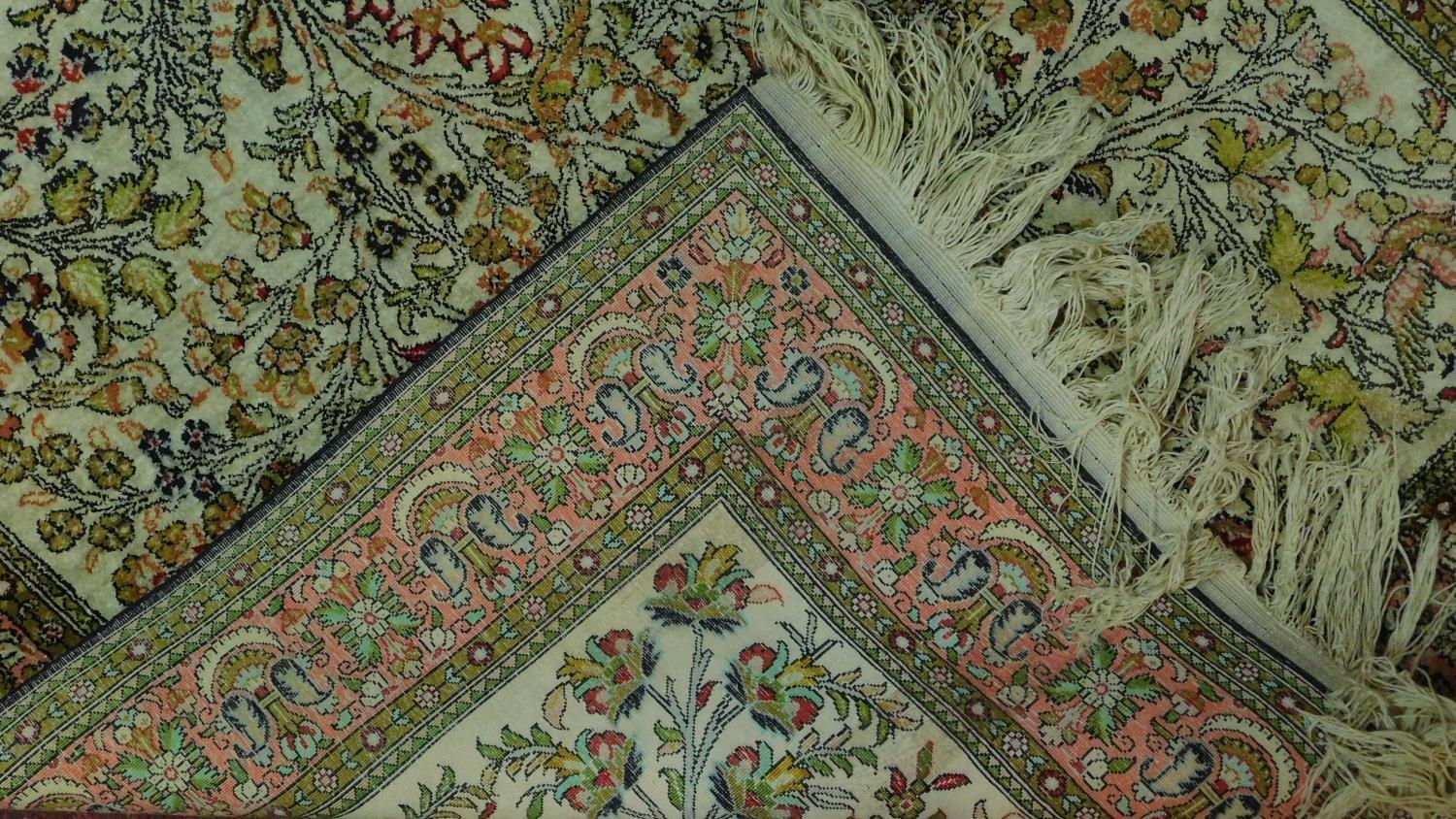 A Persian rug depicting a tree with repeating spandrels and petal motifs surrounded by geometric - Image 4 of 4