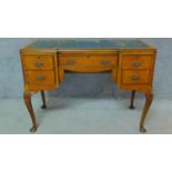 A mid 20th century Georgian style burr walnut desk with blue leather top, raised on cabriole