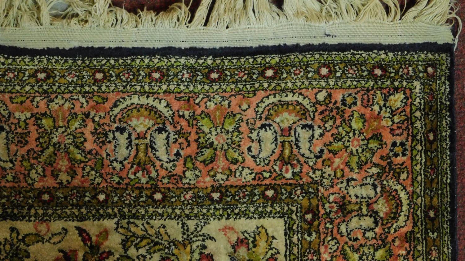 A Persian rug depicting a tree with repeating spandrels and petal motifs surrounded by geometric - Image 3 of 4