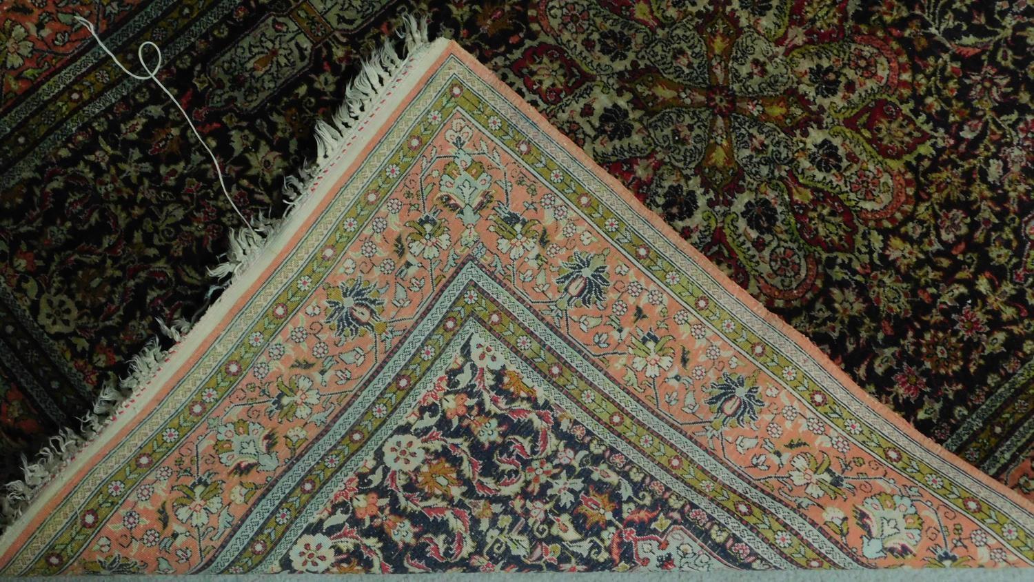 A Persian style rug with central medallion surrounded by floral motifs and a floral and geometric - Image 4 of 5