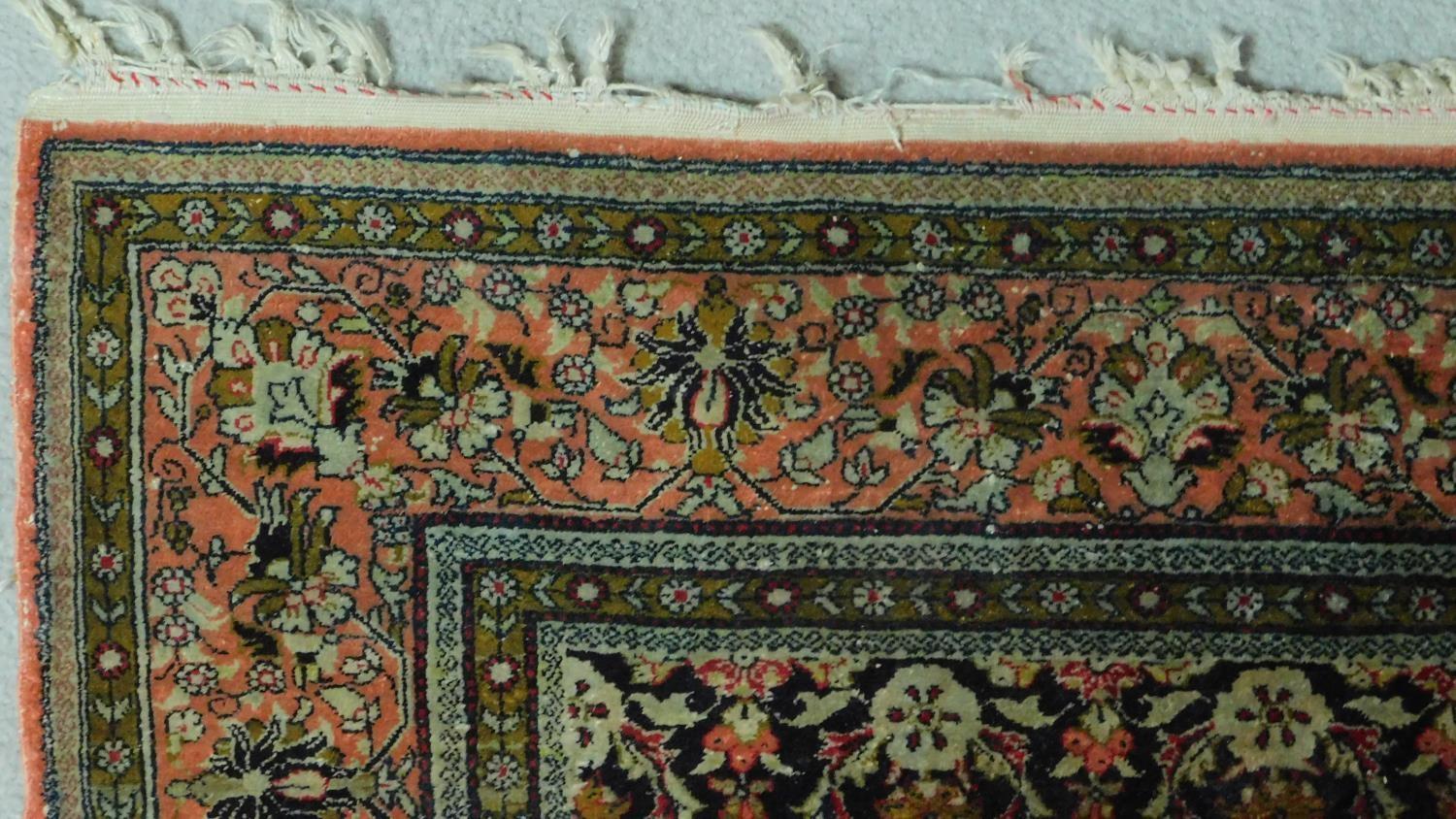 A Persian style rug with central medallion surrounded by floral motifs and a floral and geometric - Image 3 of 5