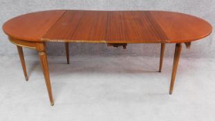 A French walnut demi lune foldover tea table with two extra leaves opening to a 6/8 seater dining