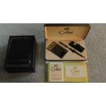 A vintage Johnny Walker cased Colibri of London stationery set including a calculator, lighter and