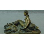An antique cast brass statue of a lady with a cherub and a dolphin. H.31 W.55cm