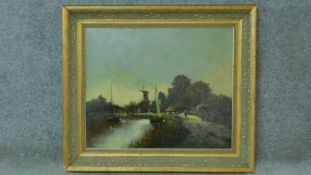 A gilt framed oil on canvas depicting a landscape with windmill, signed WL Smith. 67x78cm