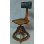 A late 19th century oak swivel adjustable industrial chair with green leather upholstery to the