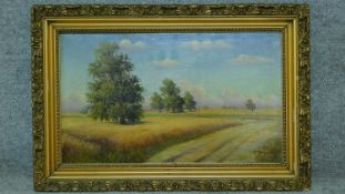 A gilt framed oil on canvas, cornfield, indistinctly signed. 56x84cm