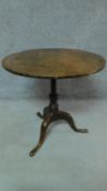 A Georgian oak circular tilt top table raised on cabriole tripod base. H.68 W.73 D.73cm