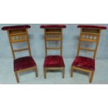 Three late 19th century Gothic style oak prie dieu chairs in burgundy velour upholstery. H.95cm