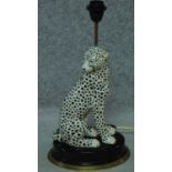 A contemporary porcelain cheetah lamp with a brass rim to the base, by House of Hackney. H.50cm