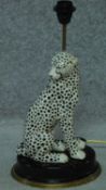 A contemporary porcelain cheetah lamp with a brass rim to the base, by House of Hackney. H.50cm