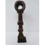 A wooden African tribal tool on metal display stand. H 25cm.