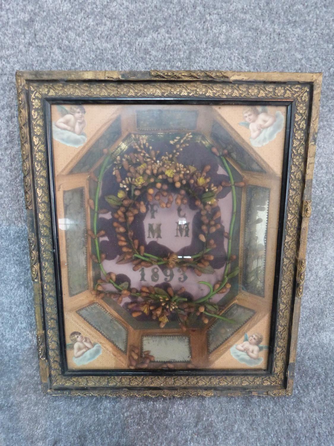 An early Victorian framed wax flower marriage wreath, circa 1893. Carved gilt frame and mirror panel