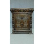A 19th century Flemish carved oak pier cabinet with frieze drawer above panel door. H.111 W.96 D.